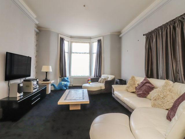 A living room with a sofa and television at Luxury Winter Gardens Apartment 2 in Blackpool