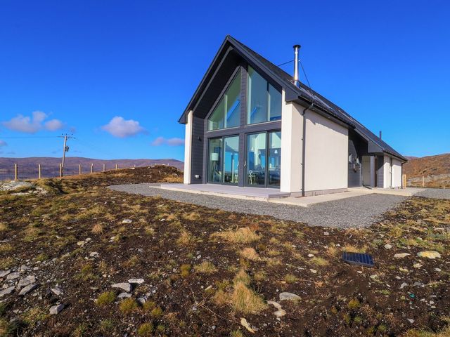 A house with large windows and a pathway at 8B Carrigreich Isle of Harris