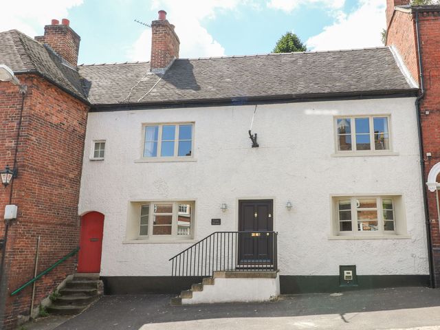 A house with a black door and red accents at Lion House in Ashbourne