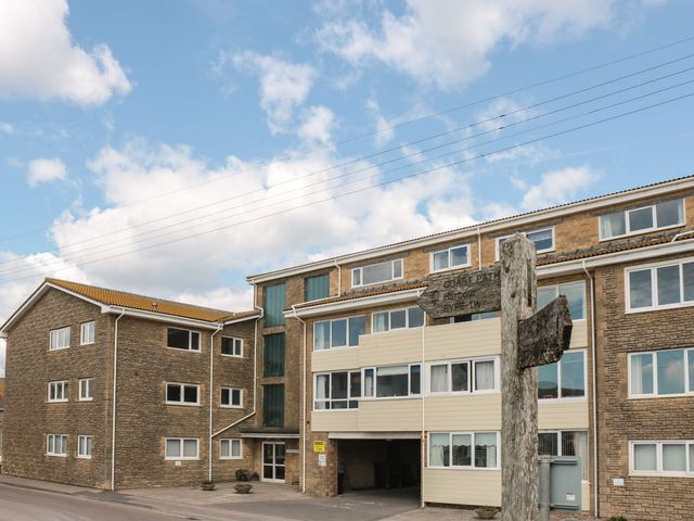 A building with windows and a signpost at Flat 30 Bridport