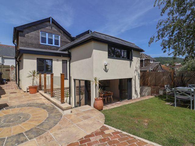A house exterior with garden and outdoor dining table at Mayflower Cottage Lyme Regis