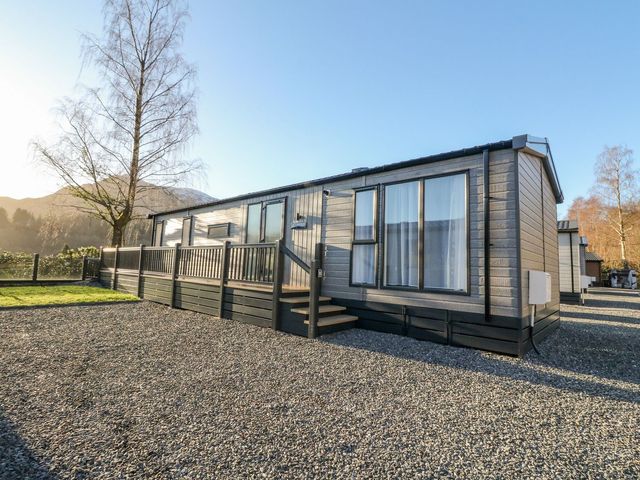 A mobile home with a deck and steps in the outdoor area at Hollybirch in Crieff