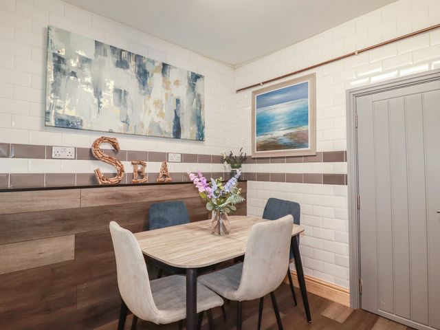 A dining room with a table and chairs at Penthouse No.3 in Newquay