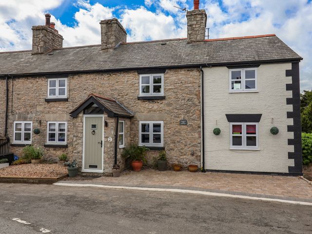 A house with a front door and windows at Tenandeleven Cottage in Denbigh