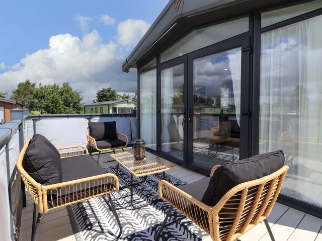 A balcony with seating and table at Lodge - Plot 18 Near Sherburn