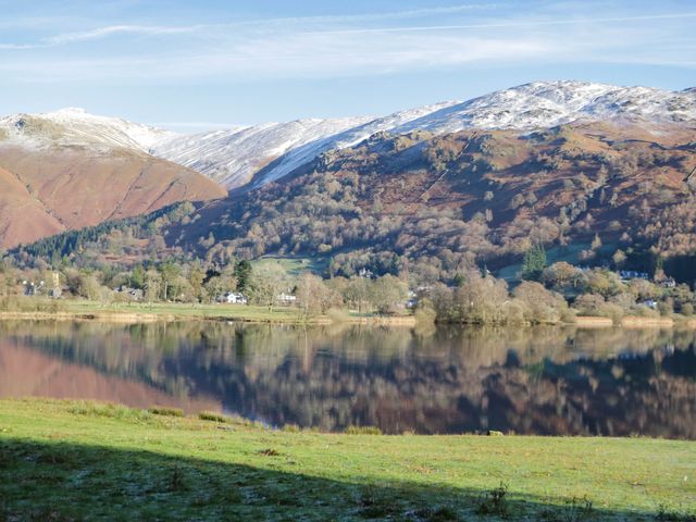 A lake surrounded by mountains and trees at Flat 4 Grasmere Lodge Ambleside