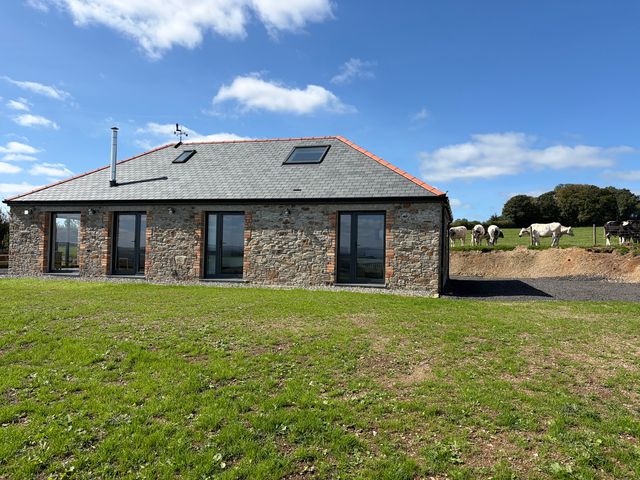 A stone building with windows and a roof at High View Barn in Launceston