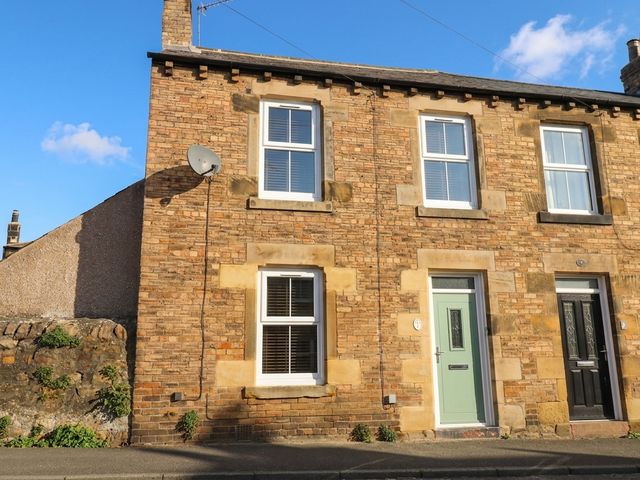 A house exterior with brick wall and windows at Corner House in Wark