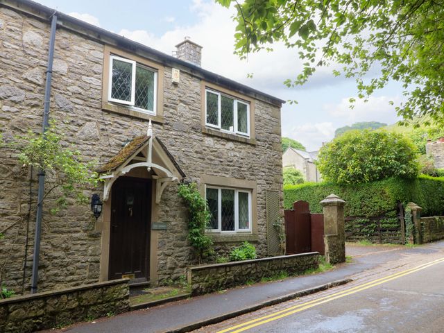 A stone house with windows and a door at The Chimes in Hope Valley