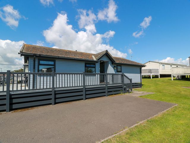 A house with a deck and railing at Queensway QW1 Dumfries