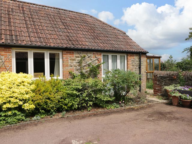 An exterior view of a house with plants and a garden at The Garden Studio in Bremhill near Calne