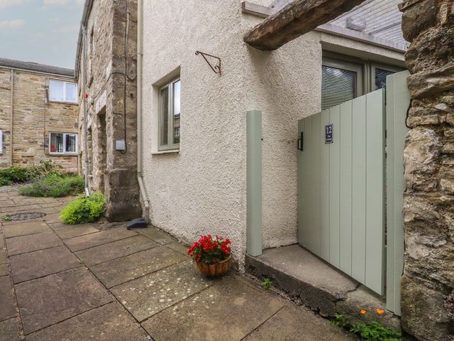 A pathway and gate leading to a property at The Cottage in Giggleswick