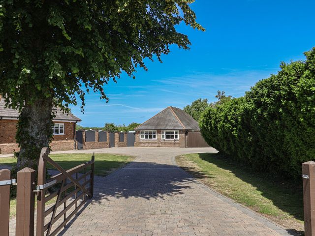 An outdoor view of a building with a driveway at Frome View in Wool