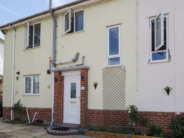 A front exterior view of a house with a white door at 167 Leybourne Avenue in Bournemouth