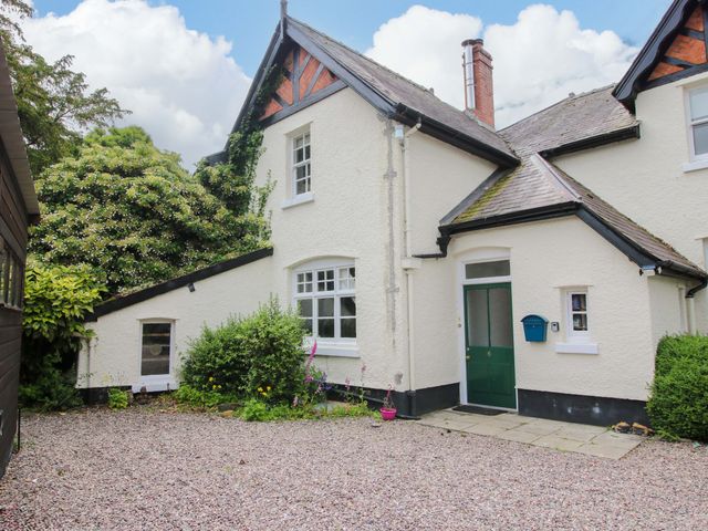 A house exterior with a green door and bushes at Kwerky Cottage 