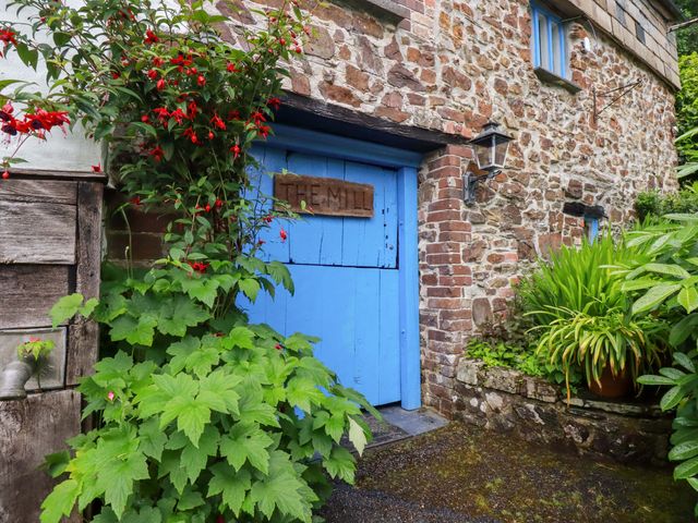 An exterior view of a blue door with wooden sign The Mill at The Water Mill at Boyton Mill Launceston