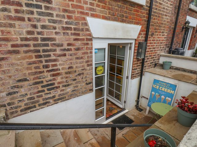 An outdoor entrance with a door and steps at Apartment Yellow in Whitby