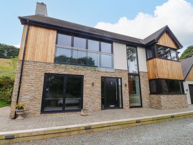 A modern house with stone and wood facade at The Barn at Bryn Eithin Colwyn Bay