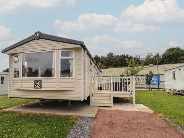 A mobile home with a deck and steps at 10 Cambrian Park in Pwllheli