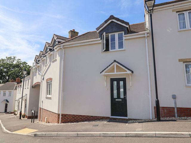 A residential building with a front door and windows at L'Ancresse Cottage in Lyme Regis