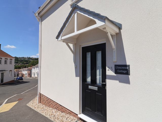 An entrance door with an awning at L'Ancresse Cottage in Lyme Regis