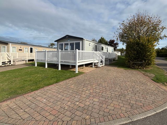 A mobile home with a deck and steps at Primrose Valley Park - Pebbles Retreat, Primrose Valley