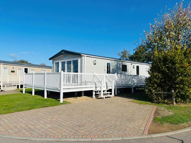 A mobile home with a deck and steps at Primrose Valley Park - Pebbles Retreat in Primrose Valley