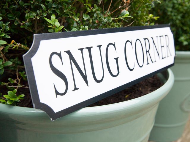 A sign that reads Snug Corner next to a plant at Snug Corner in Honley