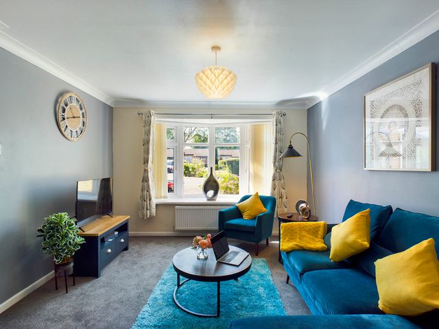 A living room with a sofa, armchairs, and television at Tranquil Telford Retreat - 3 Bedroom House, Telford