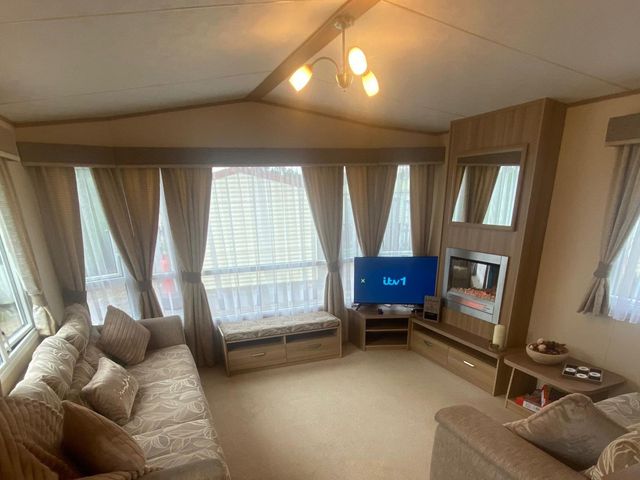 A living room with a television and sofa at The Old Barn in Manchester