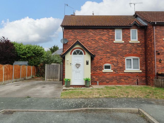 A brick house with a front door and windows at Robins Nest in Rhyl