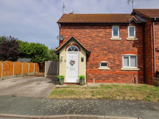 A house with a front door and windows at Robins Nest in Rhyl