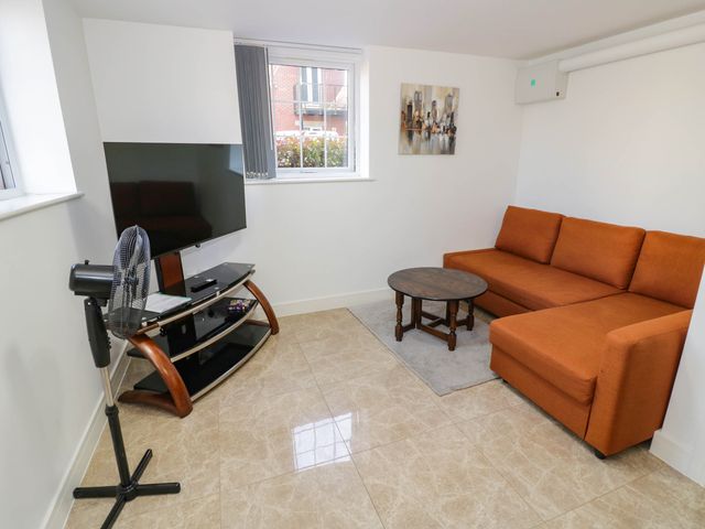 A living room with a sofa and a television at 1 Pump House in Smethwick