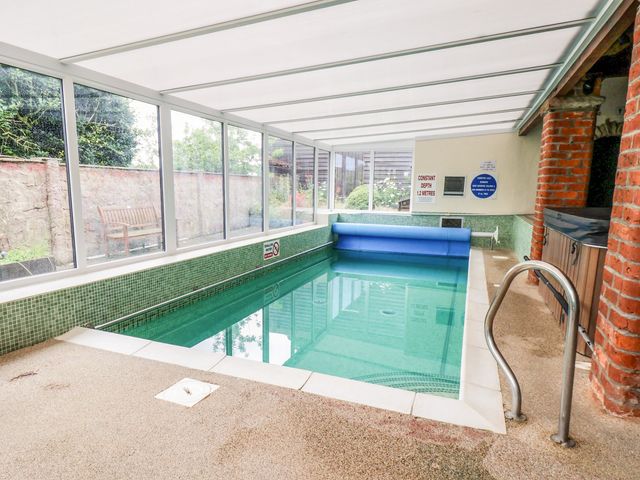 An indoor swimming pool with a pool cover at Granary in peterculter