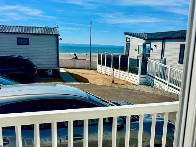 View of houses and beach from a balcony at Trecco Bay in Porthcawl