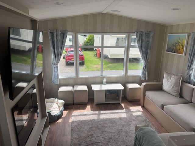 A living room with a sofa and coffee table at Haggerston Castle Lakeside East 76, Berwick-upon-Tweed