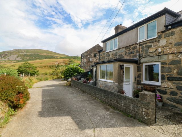 A house with a driveway and garden near a mountain at Tyr Felin near Trefor