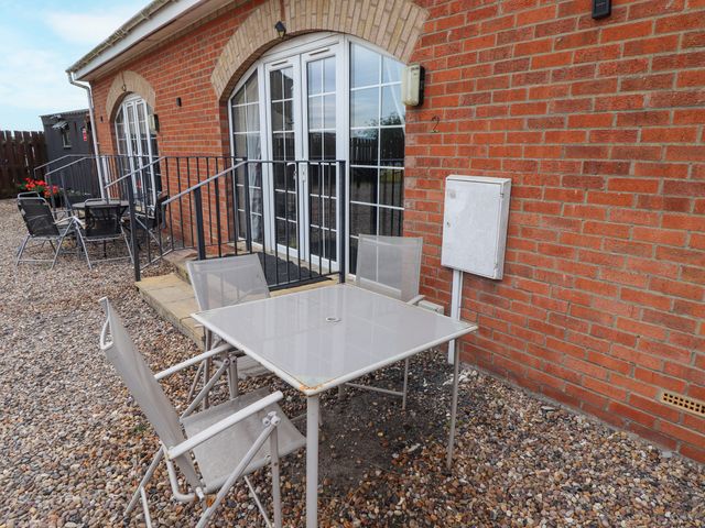 A table and chairs outside at Holiday Cottage 2 in Skegness