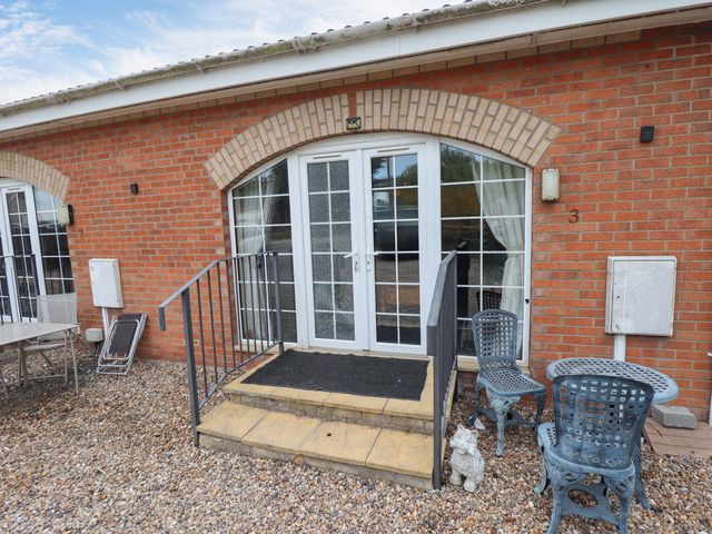 An entrance with steps and seating area at Holiday Cottage 3 Skegness