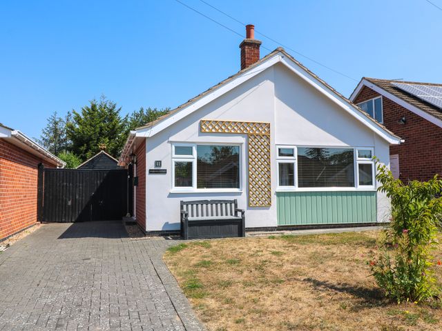 A house with a front door and garden at Pinecote Cottage Nottingham