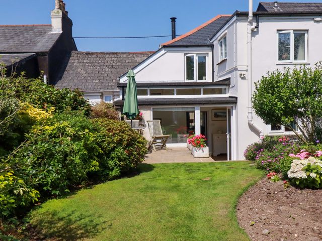 A garden with a house and patio furniture at Mary’s House in 