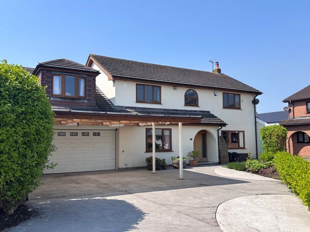 A house with a garage and driveway at 7 Adrian Close in Porthcawl