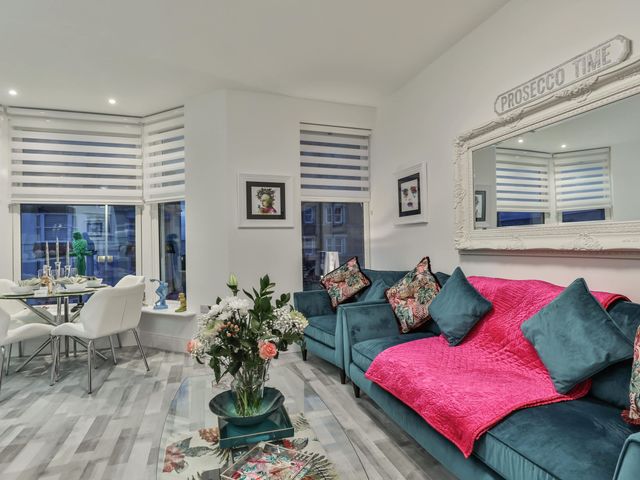A living room with a sofa and dining area at 1 Bed Flat - Sleeps 2 - Parking - Wifi in Scarborough