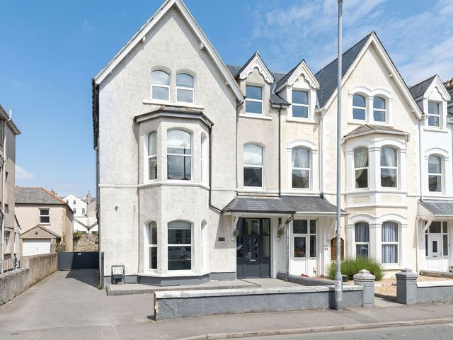 A house with multiple windows and a door at Holiday home guest house in Llandudno