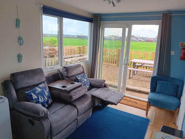 A living room with a sofa and armchair at Bay View Chalet 2 Bed Sleeps 4 Pets Garden Beach Wilsthorpe near Bridlington