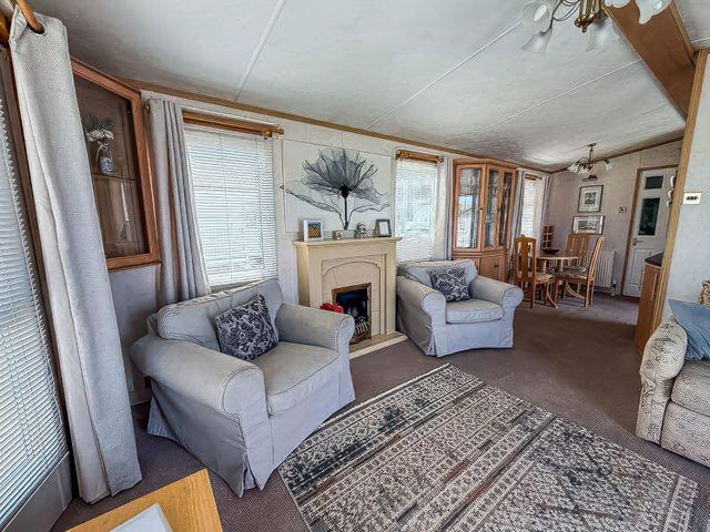 A living room with sofas and a dining area at Super 2 bed 6 berth caravan pets go free, Hunstanton