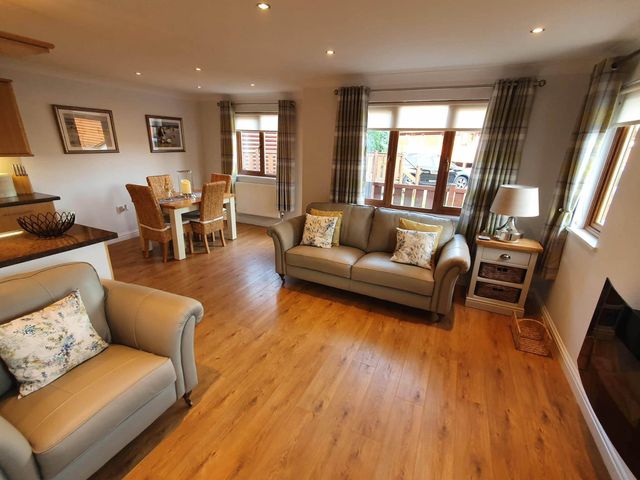 A living room with seating and dining area at Stunning 2 Bedroom Pet Friendly Lodge in Bridlington