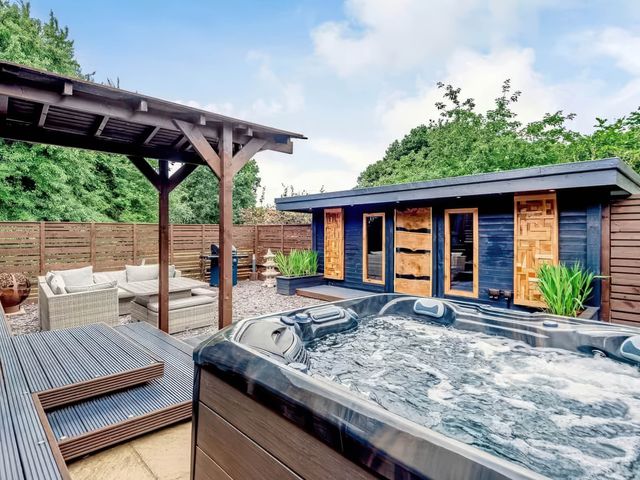 An outdoor area featuring a hot tub and seating at Luxury 2 bedroom Lodge in rural lincolnshire