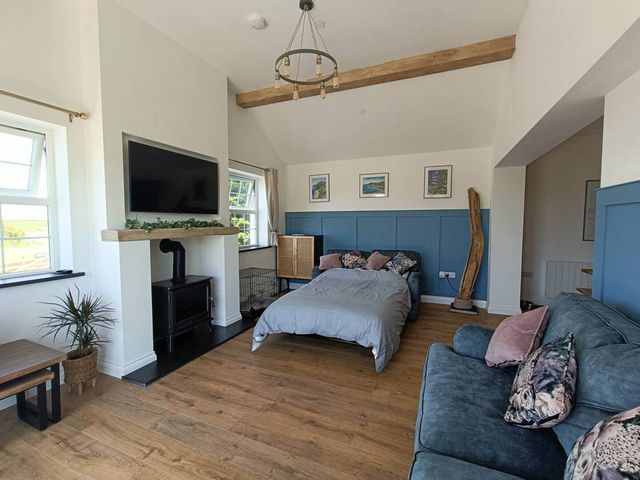 A bedroom with a bed and sofa at Aberporth 2 Bed Cottage Sleeps 4 Pet Friendly in Parcllyn near Aberporth