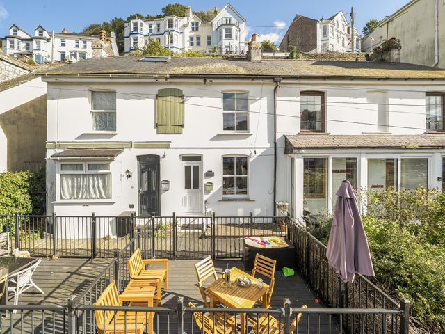 An outdoor area with a table and chairs at Looe Cottage Seaside views log fire sleeps 4 in Looe